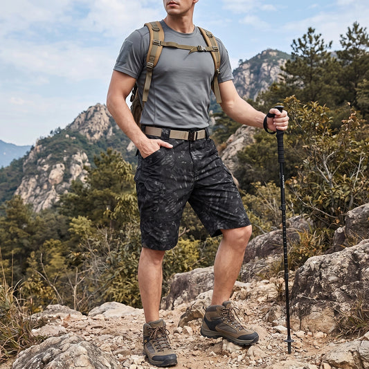 Back view of a model wearing men's functional practical cargo shorts in a versatile khaki color, showing construction details and outdoor ready style against a natural background.