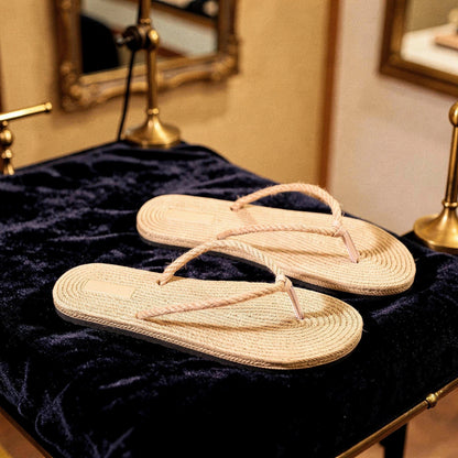 View of chic casual straw flip flop sandals in light beige with a textured surface and comfortable footbed