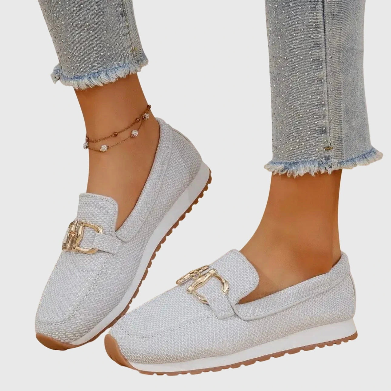 View of elegant women's loafers in soft beige leather, featuring a breathable design and subtle stitching accents