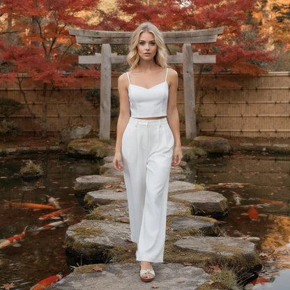 View of elegant high waisted wide leg pants in soft fabric, showcasing pleats and a smooth waistband in a neutral color