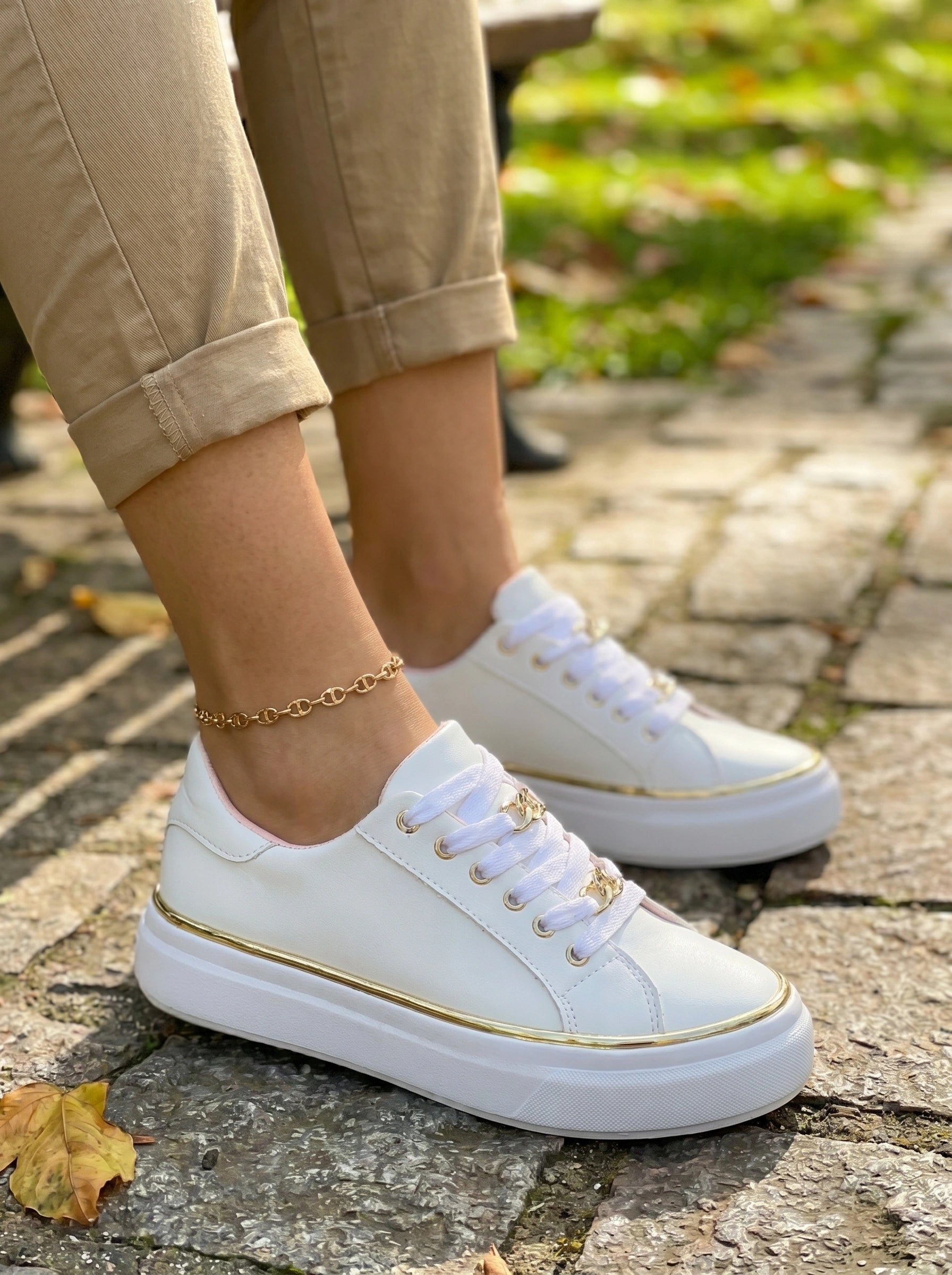 A model showcases the Womens Orthopedic Sneakers in a full front view, paired with a casual outfit in neutral tones against a minimalist background.