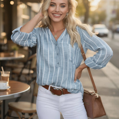 View of a relaxed striped blouse featuring soft cotton fabric, short sleeves, and a casual neckline in light blue and white stripes