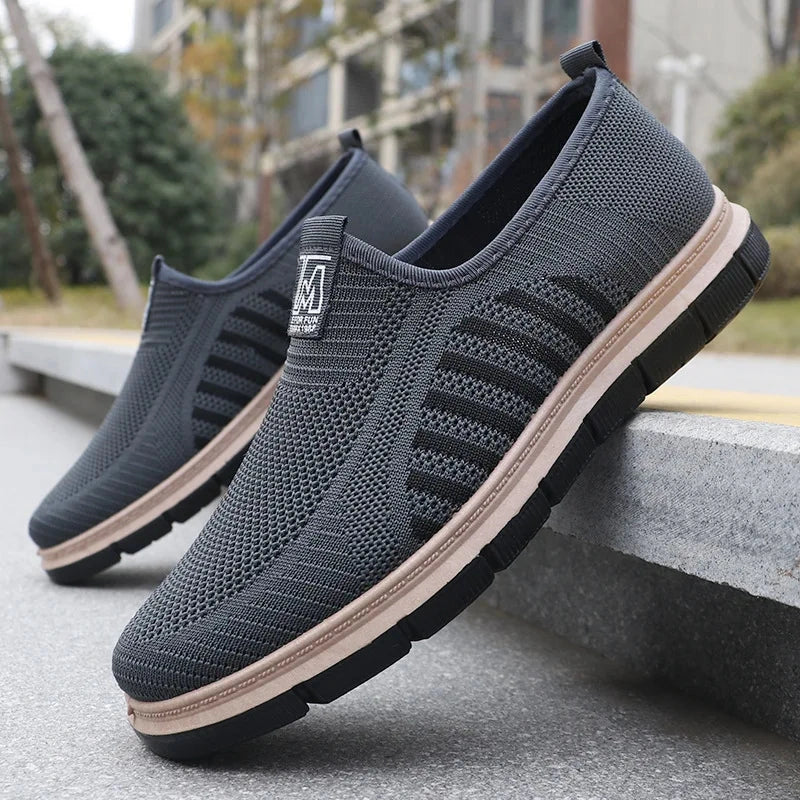 View of casual stylish shoes with a knit upper, featuring a sleek design in a light gray color