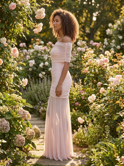 Close up view of the women's off shoulder maxi dress showing delicate pale pink mesh overlay and intricate stitching details against a soft, neutral background.