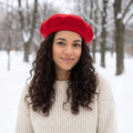 A model showcases the Womens Timeless Classic Wool Beret in a winter outfit, showing neutral tones against a soft, muted background.