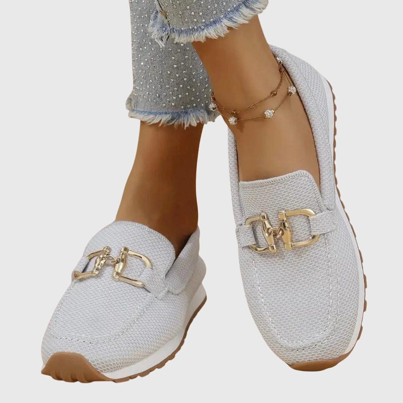 View of elegant women's loafers in soft beige leather, featuring a breathable design and subtle stitching accents