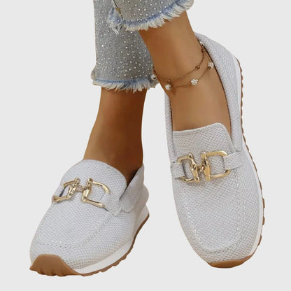 View of elegant women's loafers in soft beige leather, featuring a breathable design and subtle stitching accents