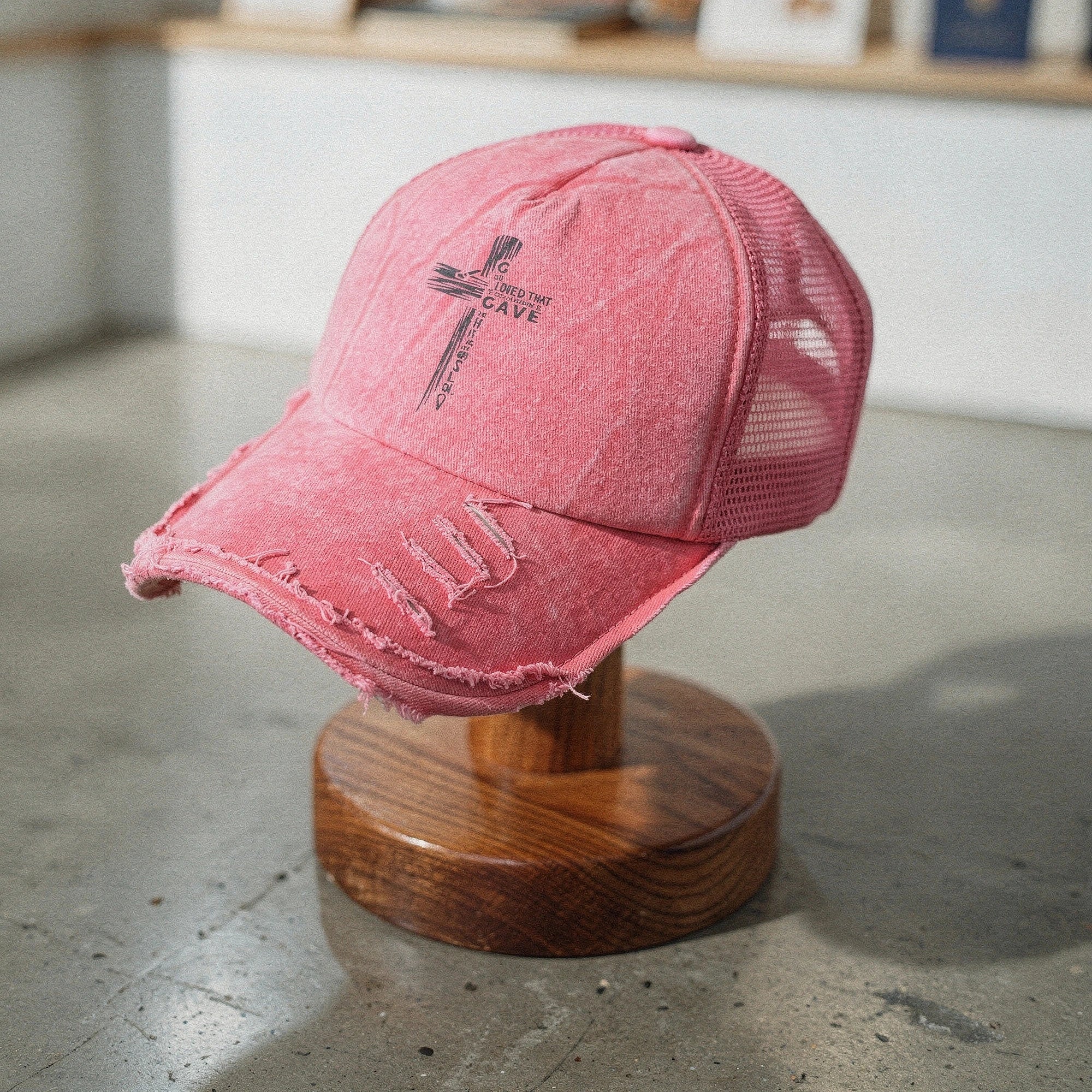 Light pink summer baseball cap made of breathable fabric, view showcasing curved brim and adjustable strap