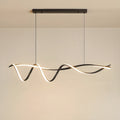 A sculptural LED overhead light fixture showcased in a modern space, showing its wave inspired design and finish against a minimalist background.