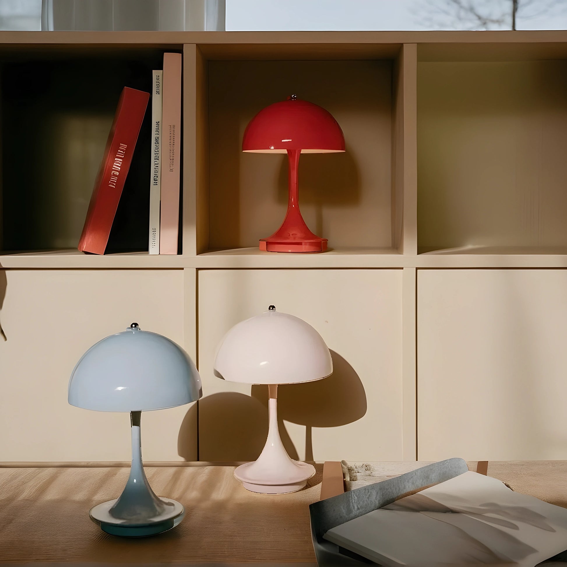 View of a sleek contemporary rechargeable table lamp in a warm metallic finish, showcasing its elegant design and unique shape