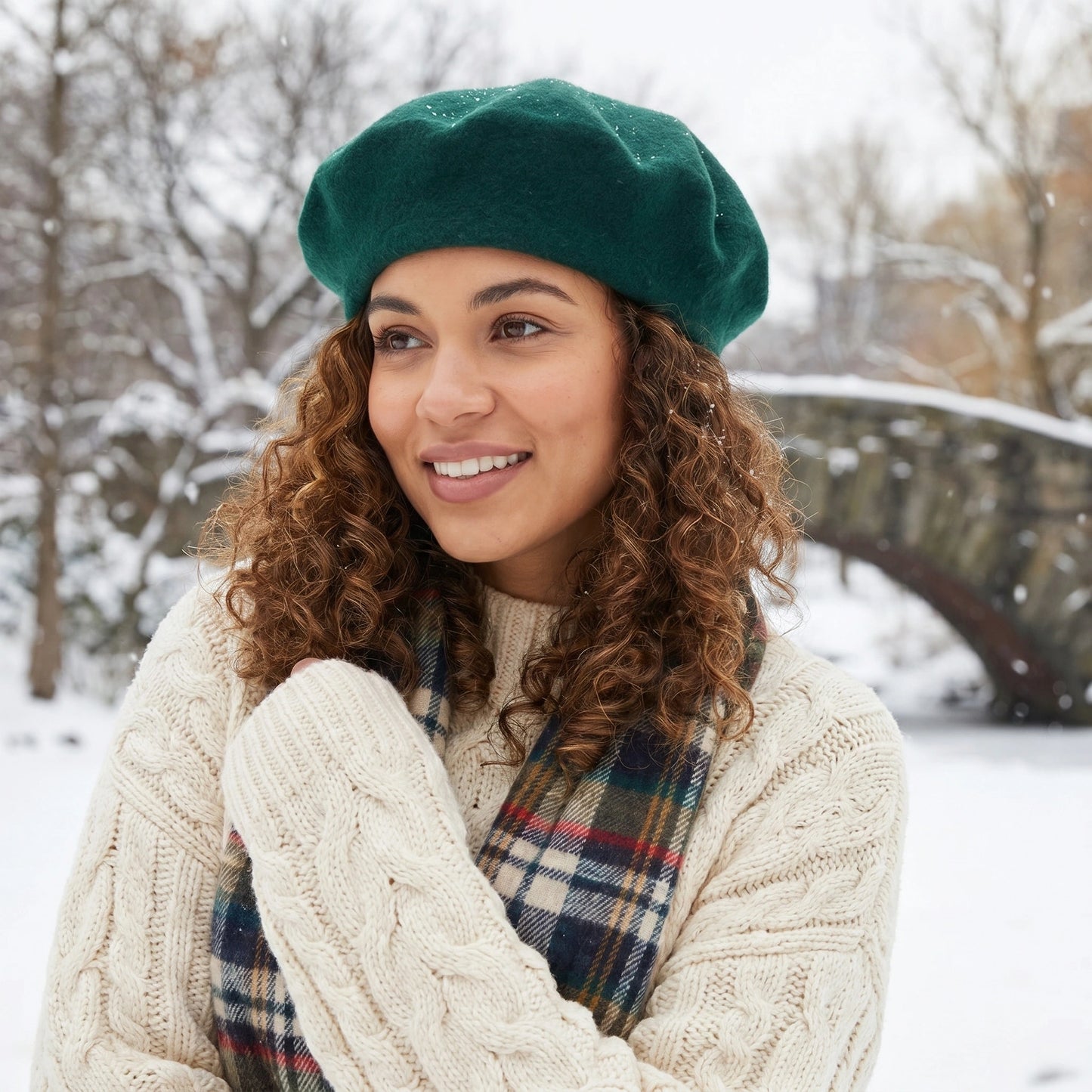 Back view of a model wearing a classic wool beret in a colorful, showing its construction details against a soft, neutral background.