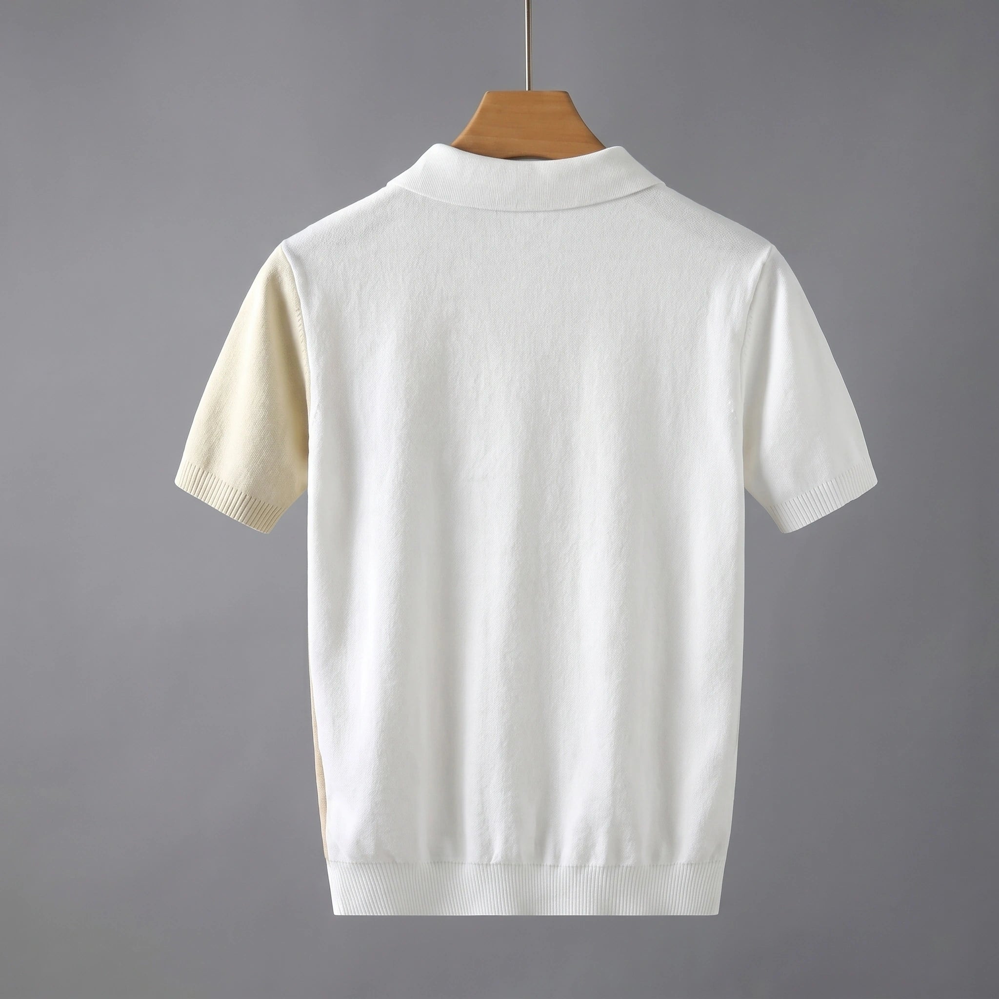 Back view of a model wearing a mens cool lightweight summer polo in a colorful, showing its sleek construction and breathable fabric against a neutral background.