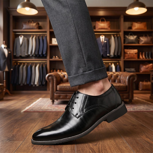 A model showcases men's lace up dress shoes in a classic black finish, paired with tailored trousers and a crisp white shirt against a neutral background.