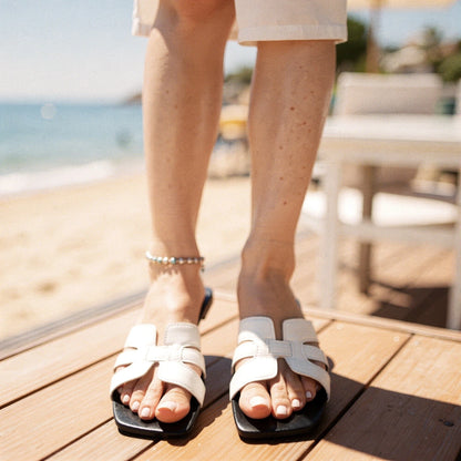 View of stylish summer slippers in soft beige fabric, featuring a cushioned footbed and open toe design