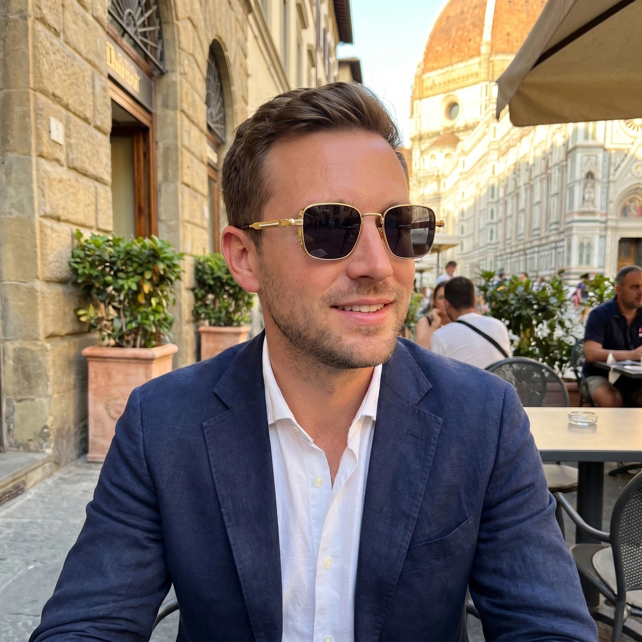 Back view of a model wearing mens sleek summer sunglasses, showing the frame's construction details against a light outdoor background.