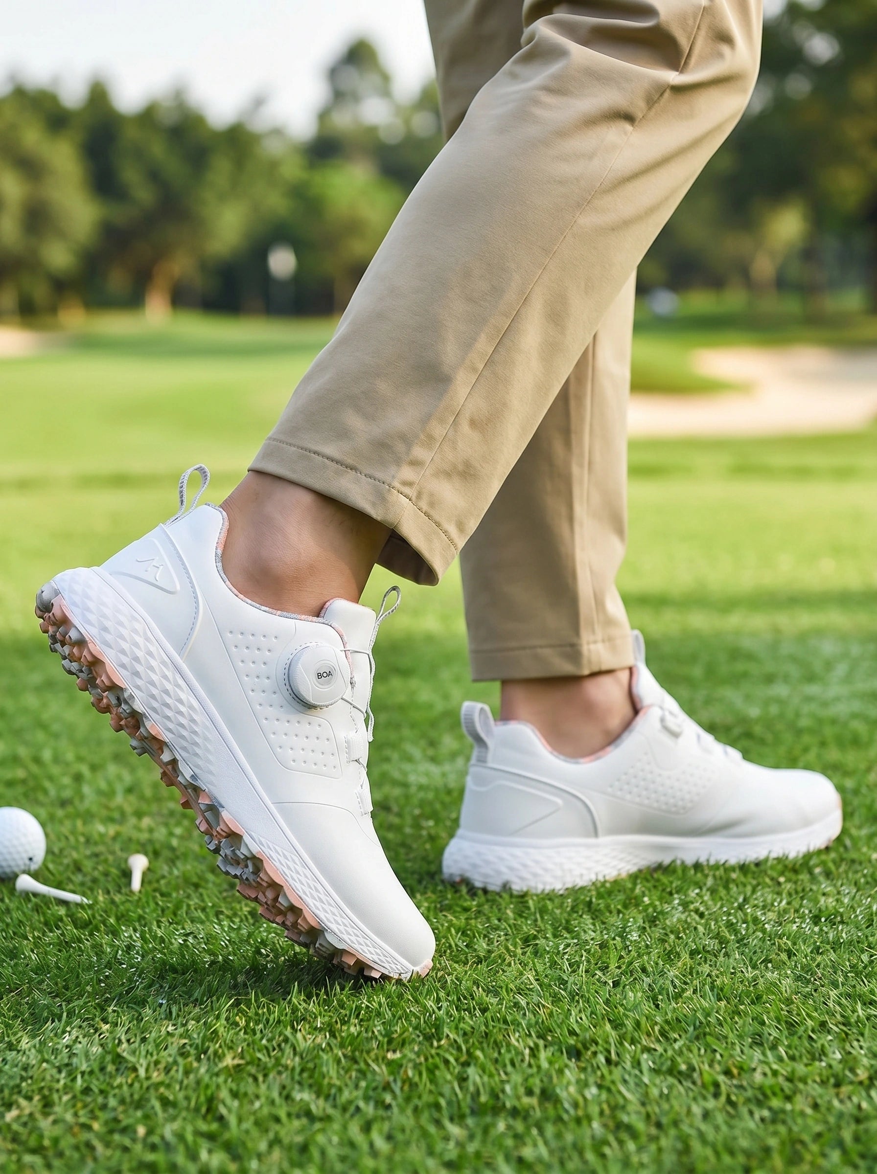 Front view of a model showing men's waterproof casual golf sneakers in a sleek design, paired with coordinating outdoor attire against a neutral background.