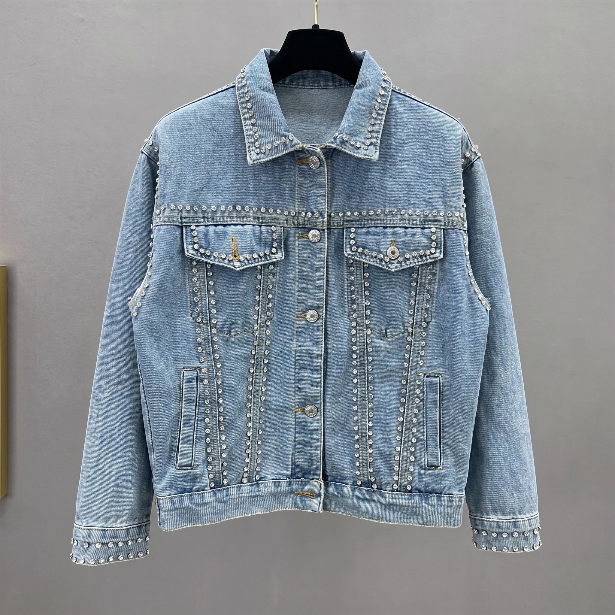 Close up view of the Womens Radiant Autumn Jacket showing its luxurious fabric texture, intricate stitching, and design details against a soft neutral background.