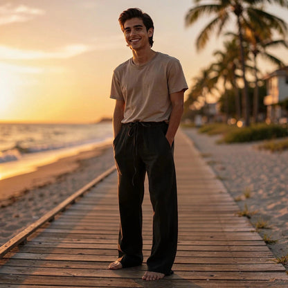 View of relaxed wide leg trousers in soft beige fabric, featuring a comfortable waistband and subtle pleats