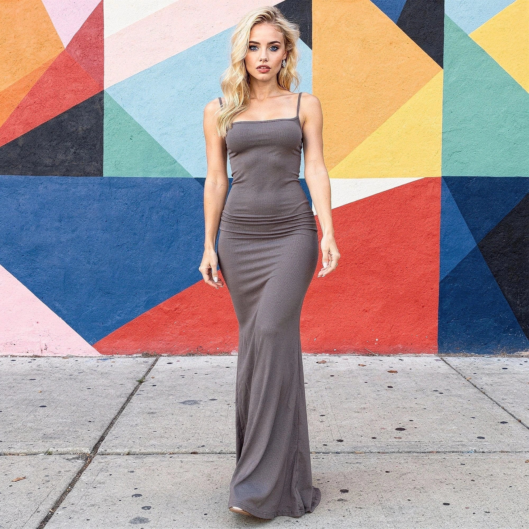 Elegant slim maxi dress in soft black fabric, featuring a fitted bodice and flowing skirt, view showcasing neckline and fabric texture