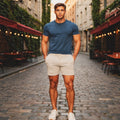 View of men's athletic fit textured jersey shorts in dark gray, featuring an elastic waistband and pockets