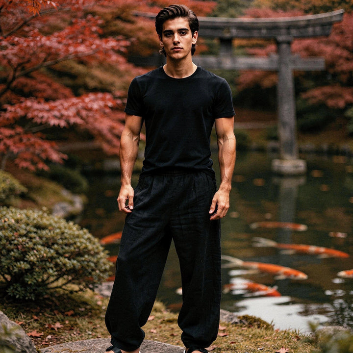 View of relaxed lightweight casual trousers in light gray fabric, featuring pockets and a comfortable waistband