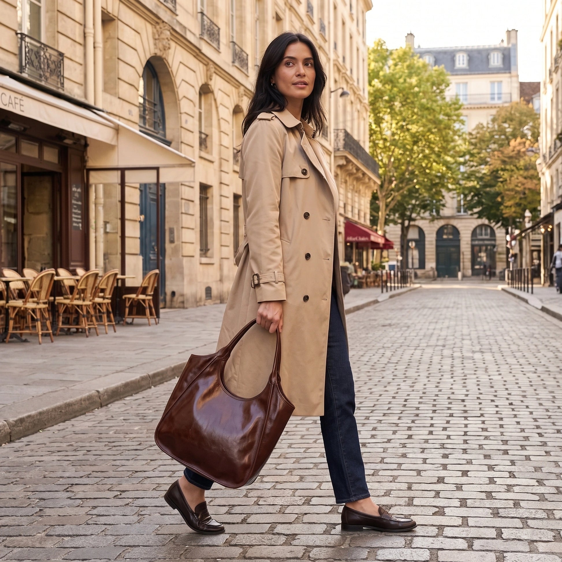 A model showcases the glossy cowhide Roma Tote Bag in outfit, showing neutral tones against minimalist backdrop. — view 2