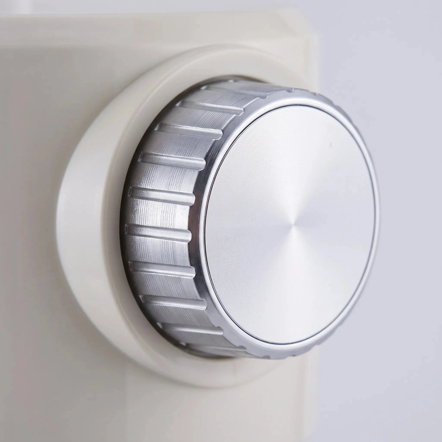 View of the ice shaver's stainless steel blades and control buttons, highlighting precision design and user friendly interface