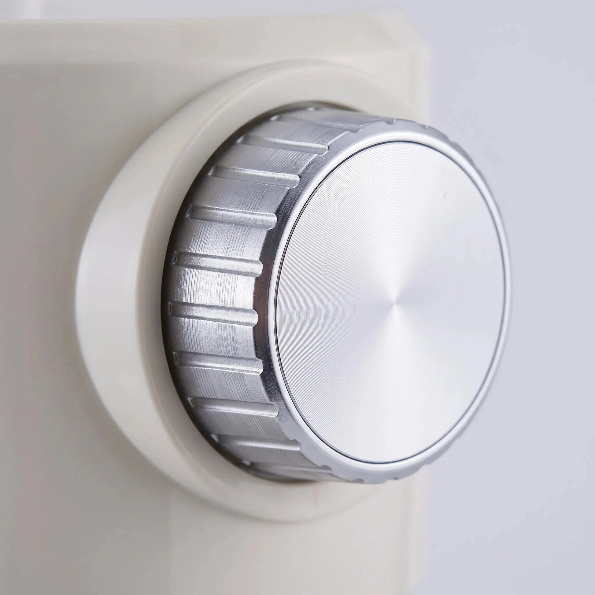 View of the ice shaver's stainless steel blades and control buttons, highlighting precision design and user friendly interface