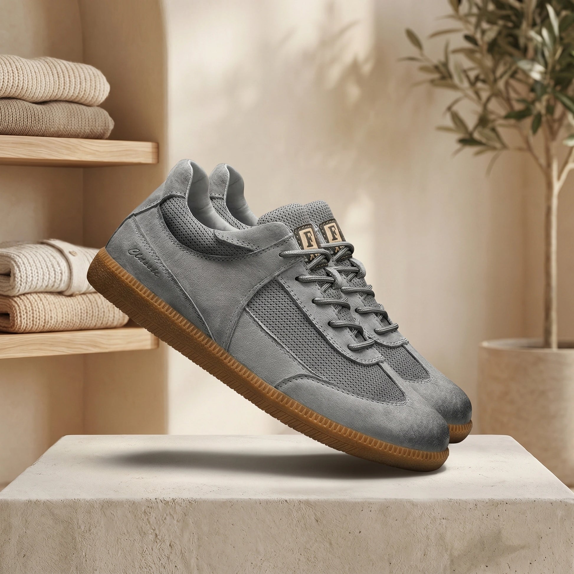 Close up of mens classic lace up sneakers showing premium fabric, intricate stitching, and a sleek design against a neutral background.