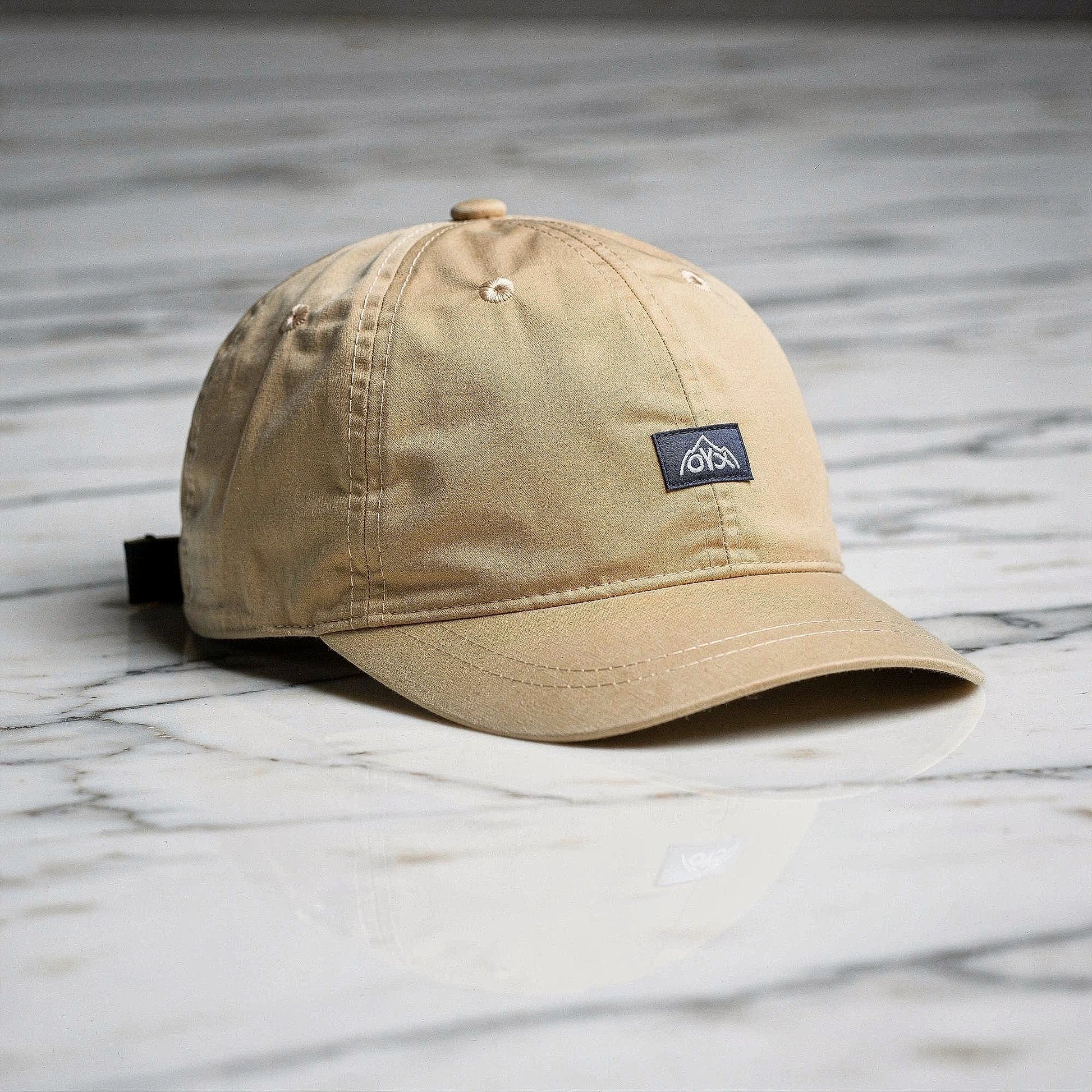 View of a stylish men's baseball cap in dark gray, made from breathable fabric, featuring a curved brim and adjustable strap