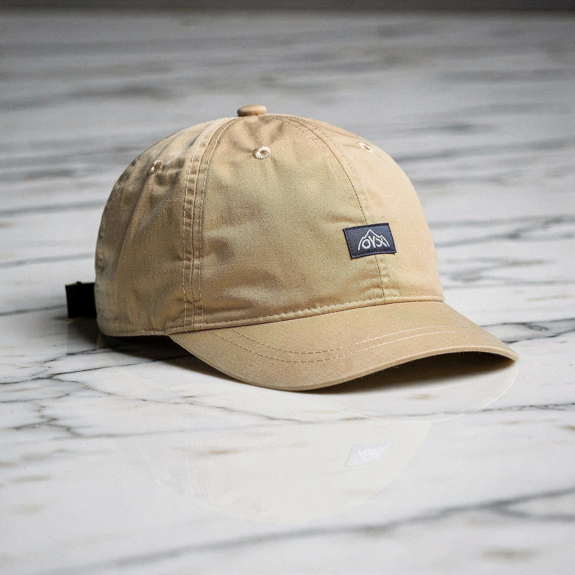 View of a stylish men's baseball cap in dark gray, made from breathable fabric, featuring a curved brim and adjustable strap