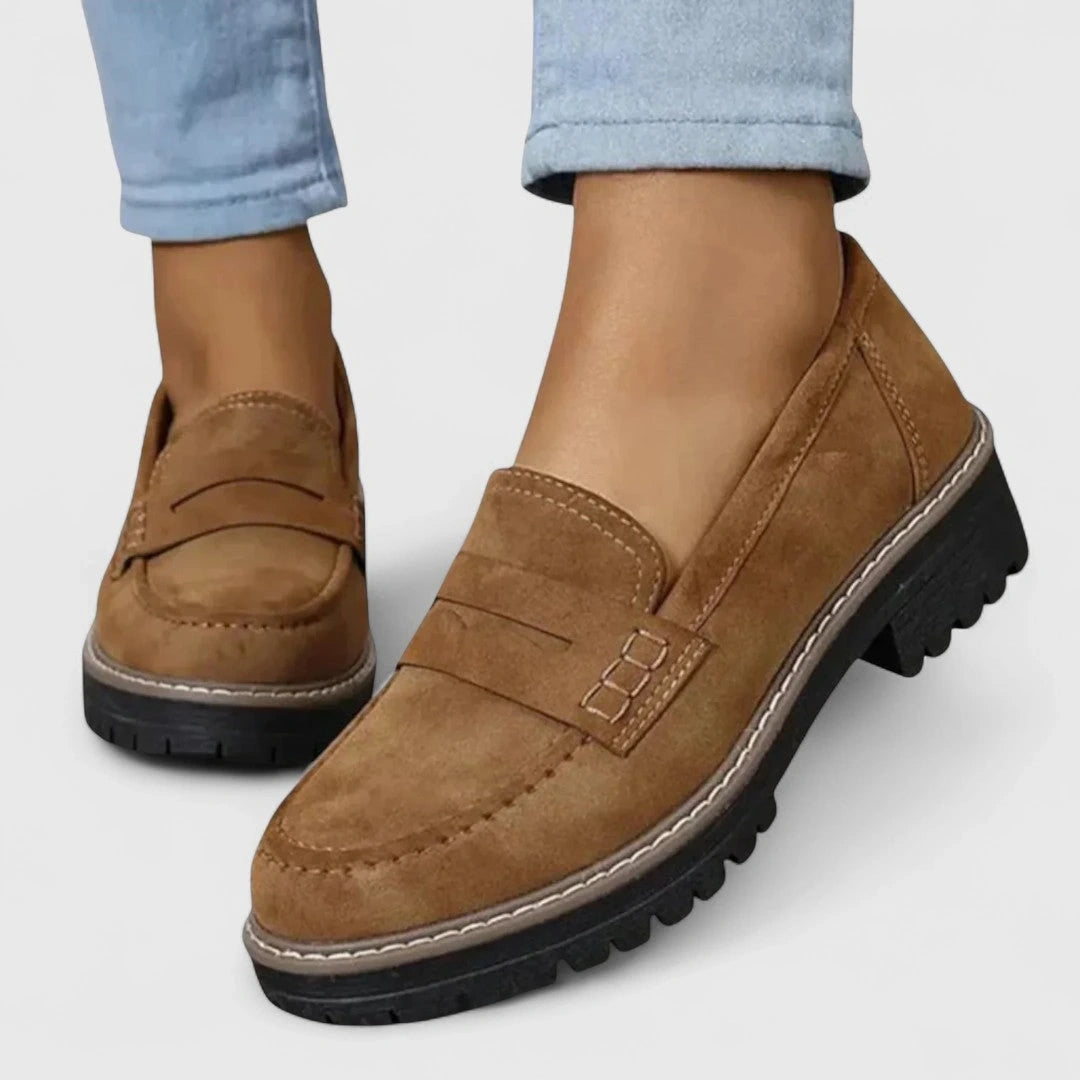 View of elegant women's loafers in rich burgundy leather, featuring a classic design and cushioned insole