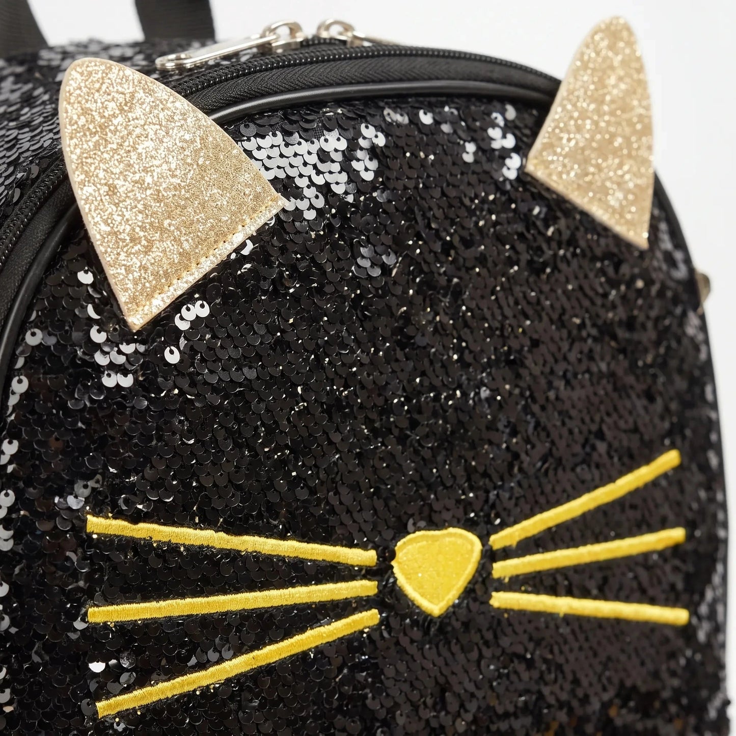 View of a shimmering cat face school backpack featuring playful colors, adjustable straps, and a durable fabric exterior