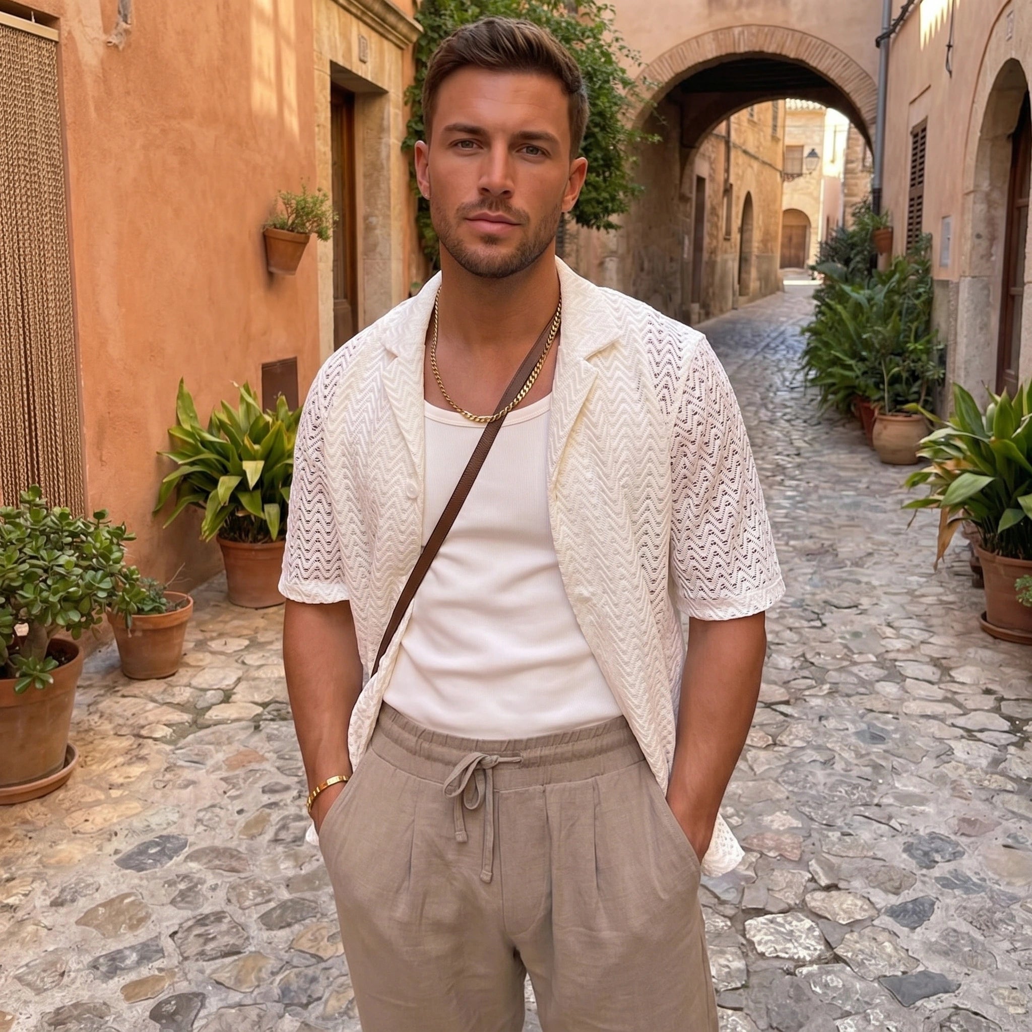 Close up of the men's sleek sophisticated summer shirt showing the fine fabric texture, precise stitching, and design elements against a neutral background.