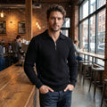 Close up view of the men's relaxed quarter zip sweater with polo collar, showing the soft fabric texture and precise stitching details in a classic navy color.