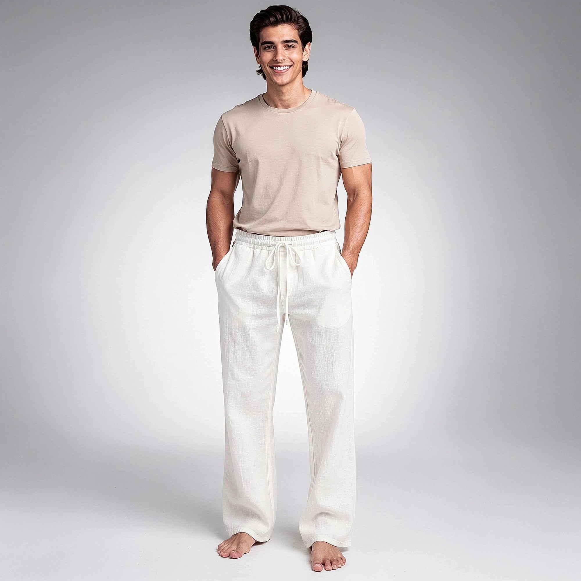 View of relaxed wide leg trousers in light beige fabric, featuring a comfortable waistband and pockets
