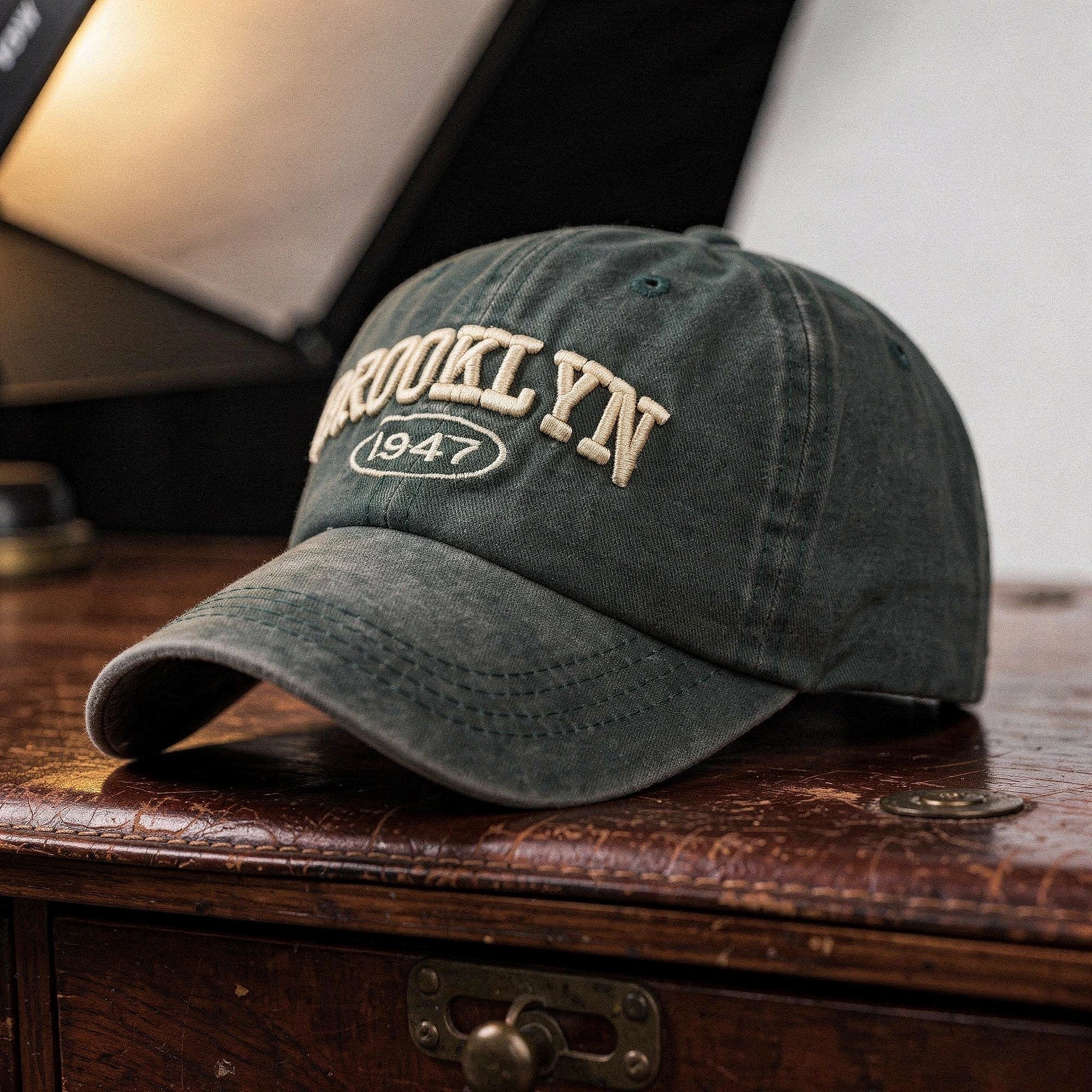 View of a casual chic embroidered cap in navy blue, featuring intricate stitching and a structured design