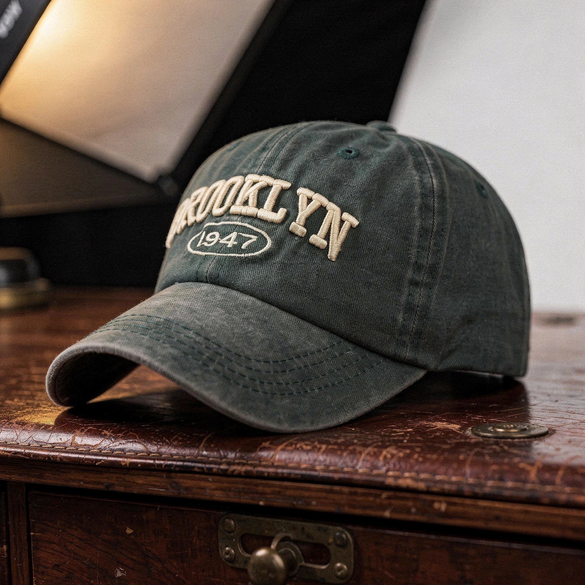 View of a casual chic embroidered cap in navy blue, featuring intricate stitching and a structured design