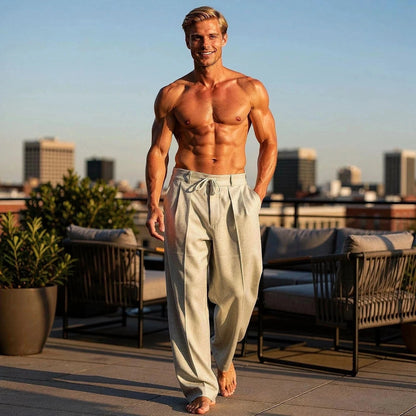 View of relaxed fit drawstring pants in light gray fabric, featuring an elastic waistband and pockets
