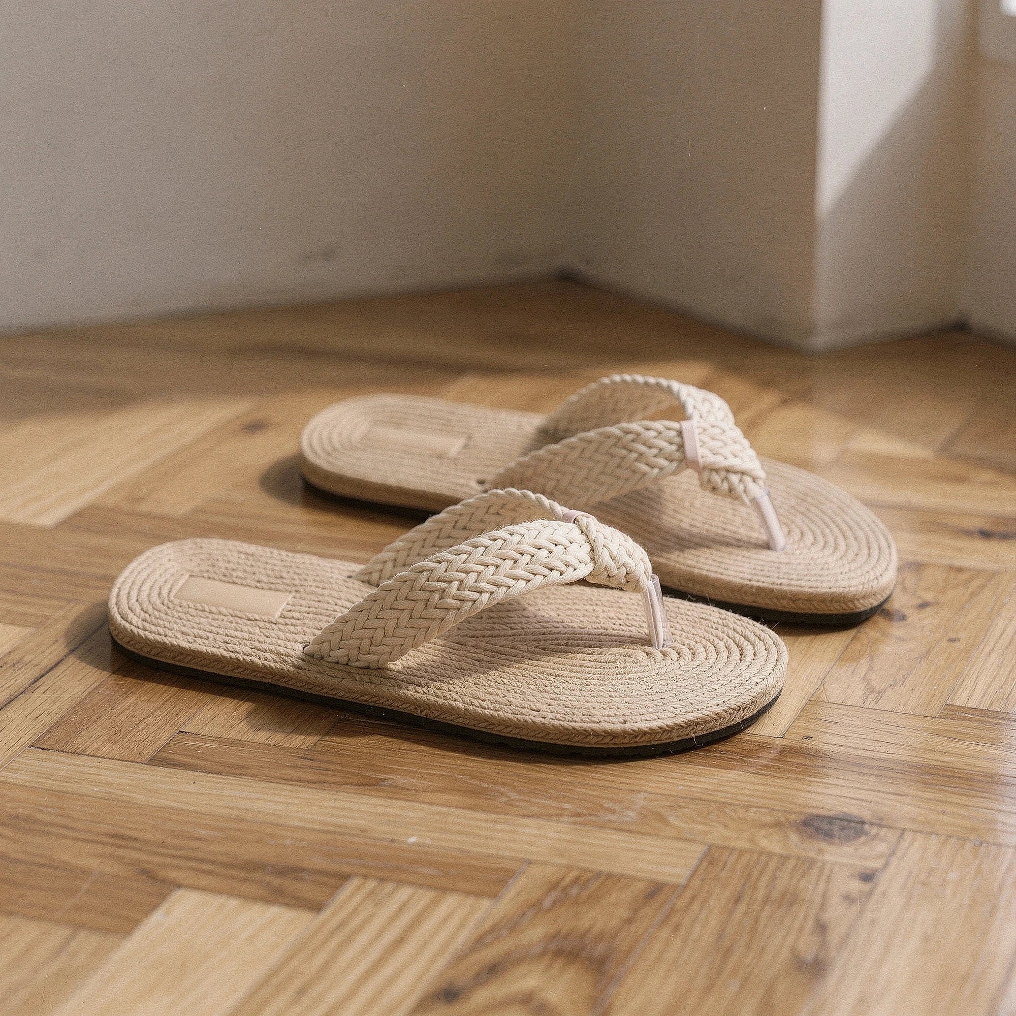 View of relaxed textured imitation hemp flip flops in natural beige, showcasing the soft material and comfortable footbed