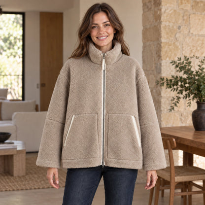 Nora fleece jacket in Khaki, complete front view worn by a smiling younger adult woman real interior
