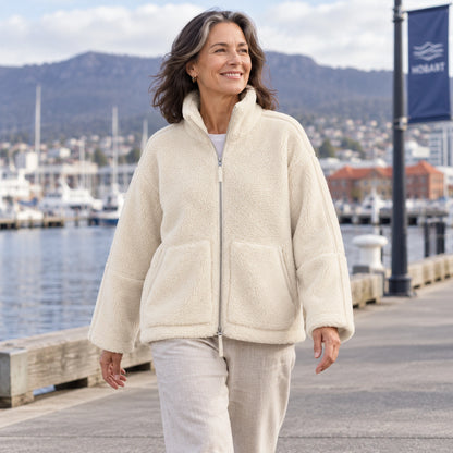 White Avalon fleece jacket, mature model walking at Hobart harbour — view 8