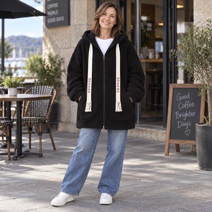 Black oversized plush fleece jacket, cafe front view — view 8