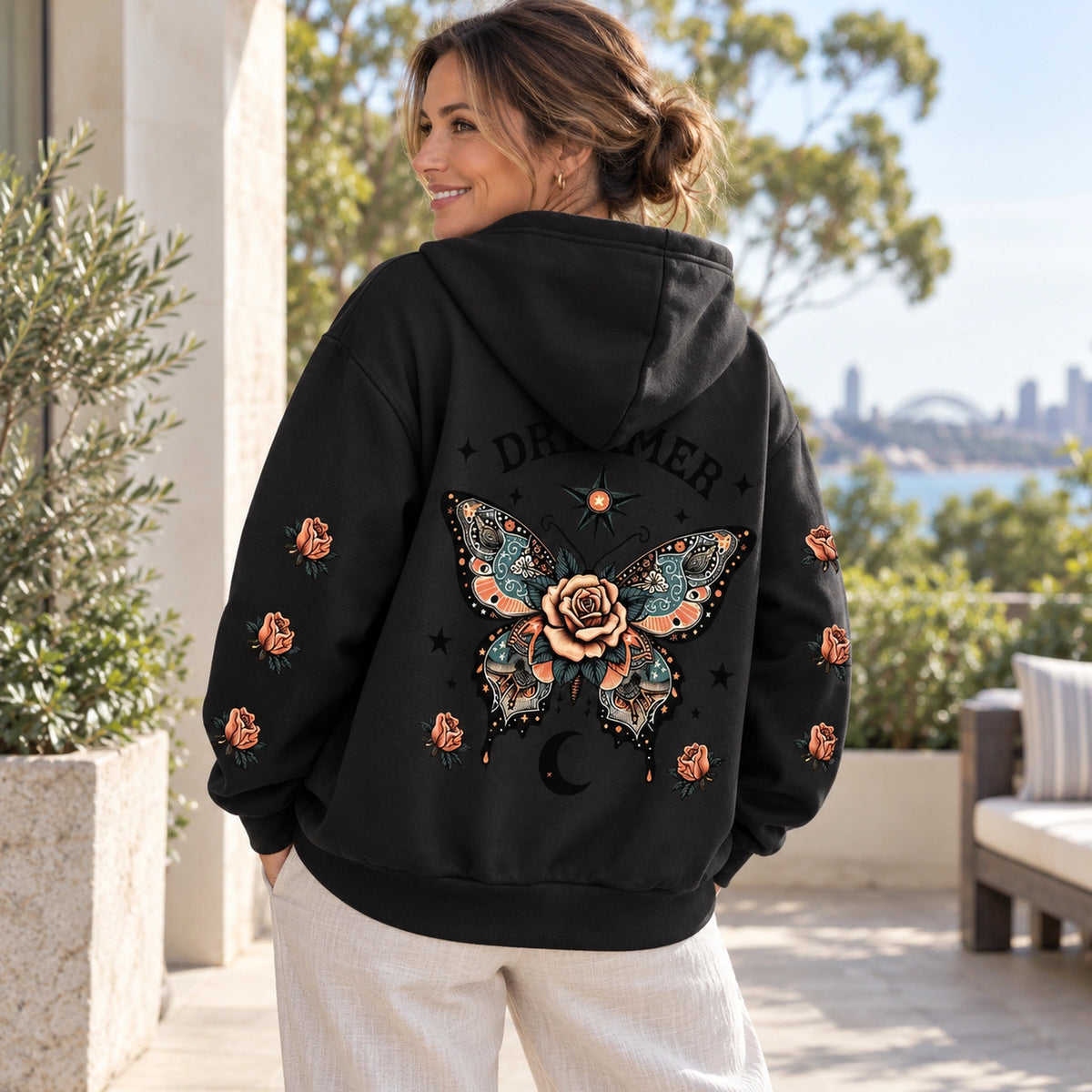 Black butterfly and rose print hoodie, rear three quarter view showing the artwork — view 4