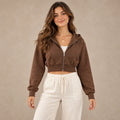 Brown Alina cropped zip up hoodie, complete front view on young model in warm neutral