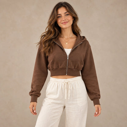 Brown Alina cropped zip up hoodie, complete front view on young model in warm neutral