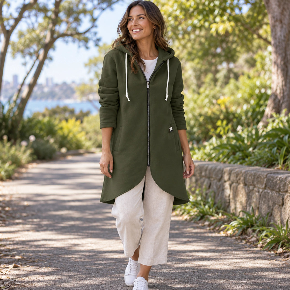 Shaly Dark Green longline zip up hoodie three quarter view, complete curved hem visible. — view 6