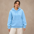 Blue Lilac pullover hoodie, complete front view on young model in warm neutral
