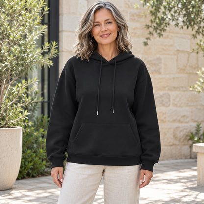 Black Lilac pullover hoodie, complete front view on mature model in Melbourne courtyard — view 2