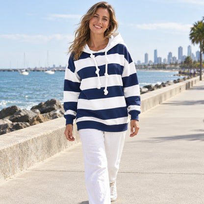 Elise Blue striped hoodie photo on a breezy Australian coastal promenade. — view 7